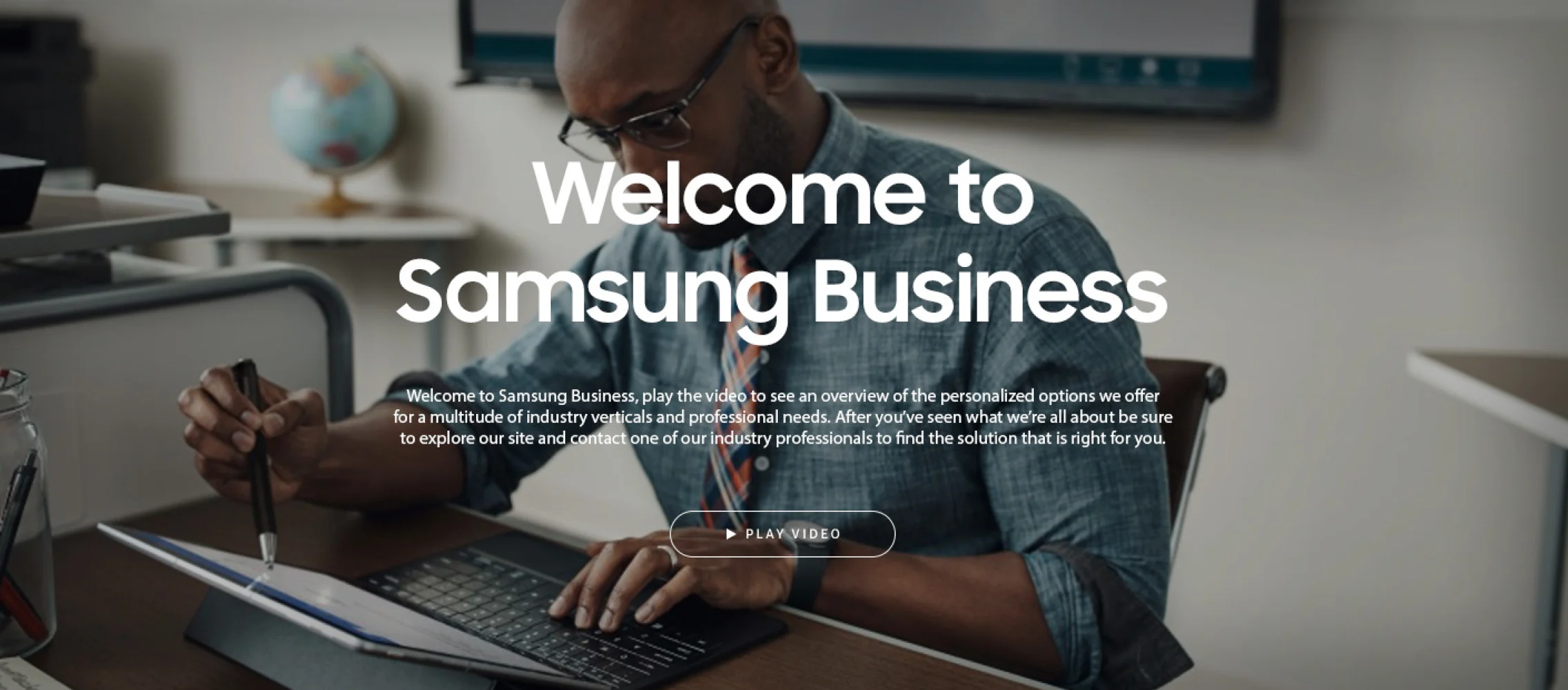 Samsung Business homepage: a man typing on a tablet keyboard under the headline “Welcome to Samsung Business” and a Play Video button.